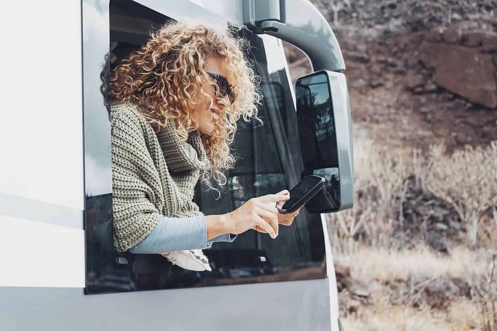 A person using a phone to access the internet in an RV